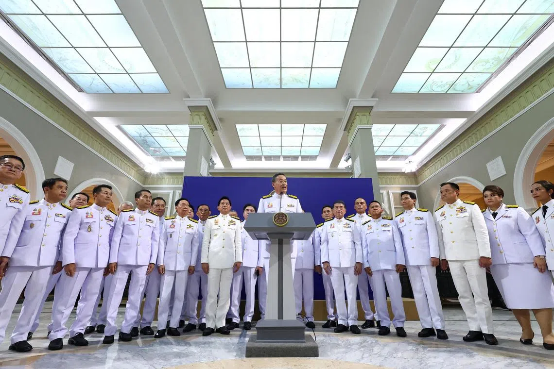 Thailand's Prime Minister Srettha Thavisin speaks next to his Cabinet members during a press conference in Bangkok
