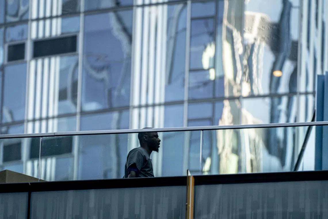 SEATTLE, WA - NOVEMBER 14: A person walks between buildings at the Amazon.com Inc. headquarters on November 14, 2022 in Seattle, Washington. Large scale layoffs are expected at the tech giant this week.   David Ryder/Getty Images/AFP

