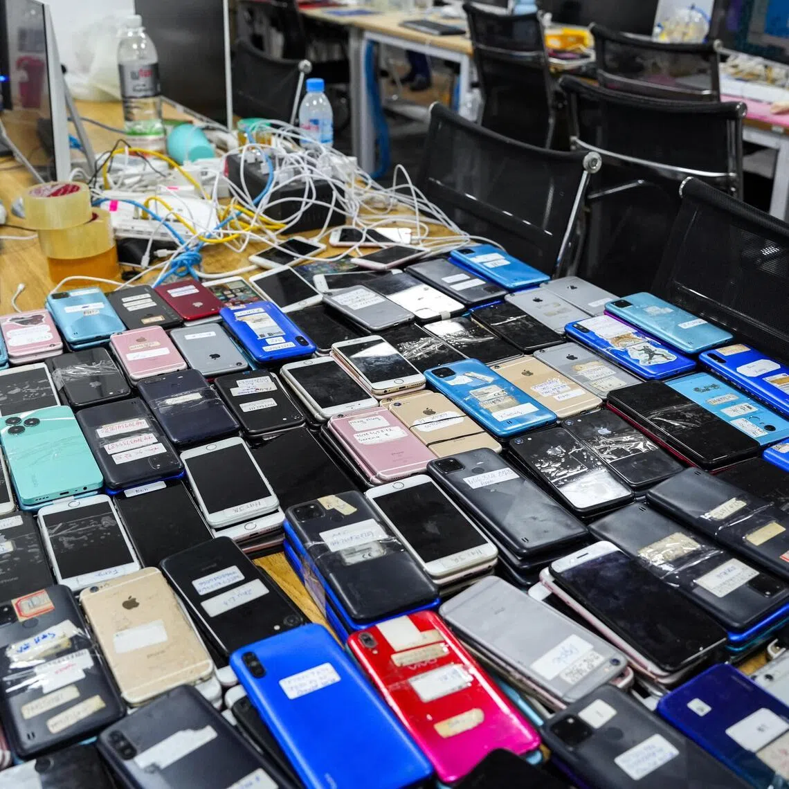 Mobile phones seized by police during an online scam crackdown at a hotel in Phnom Penh, Cambodia, in March.