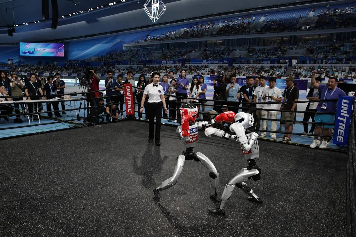 Humanoid robots take part in the free fight final match during the 2025 World Humanoid Robot Games.