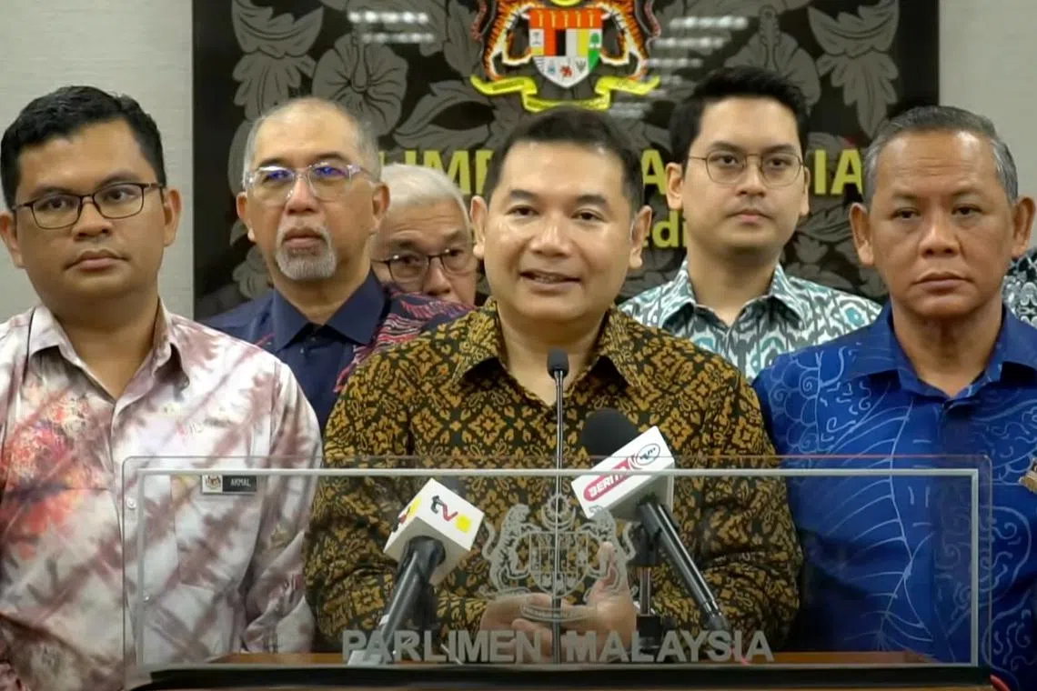 Former Malaysian Cabinet minister Rafizi Ramli (centre) said the attack was “a warning to me not to speak out on certain issues”.