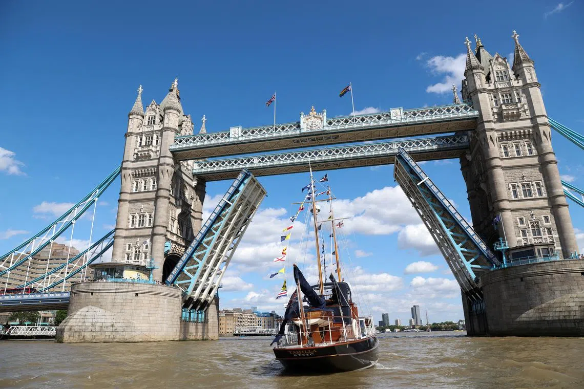 A boat passes by Tower Bridge, as 40 boats take part in a ceremonial pageant along the River Thames to mark the 250th anniversary of the Royal Thames Yacht Club in London, Britain, June 28, 2025. REUTERS/Anna Gordon