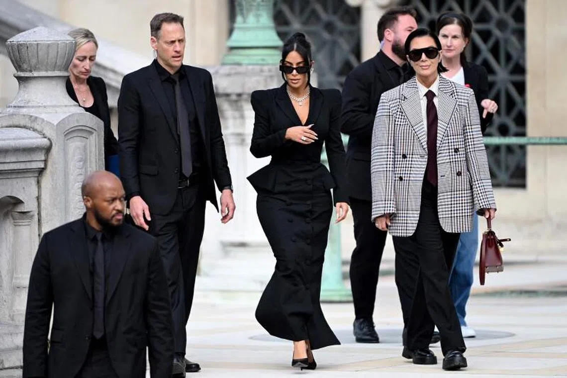 Celebrity Kim Kardashian (centre) leaves with her mother Kris Jenner (right) the Assize Court after testifying in the trial on May 13.