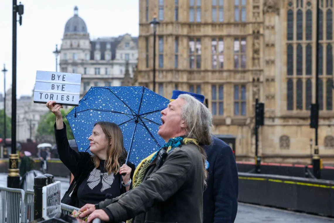 A protester carries a sign with a slogan which reads "Bye Bye Tories!", after the general election, near the Houses of Parliament in London, UK, on Friday, July 5, 2024. Keir Starmer’s Labour Party won the UK general election and is on course for a huge parliamentary majority with votes still being counted, a result that upends British politics after Rishi Sunak’s Conservatives imploded. Photographer: Betty Laura Zapata/Bloomberg