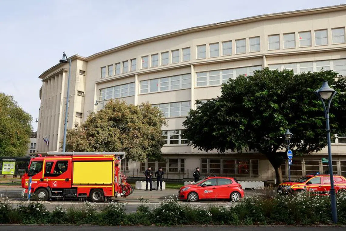French police and firefighters stand in front of the Gambetta-Carnot school, where French teacher Dominique Bernard was killed in a knife attack on Friday, after the school was evacuated following a bomb alert in Arras, northern France, October 16, 2023. REUTERS/Pascal Rossignol/File Photo