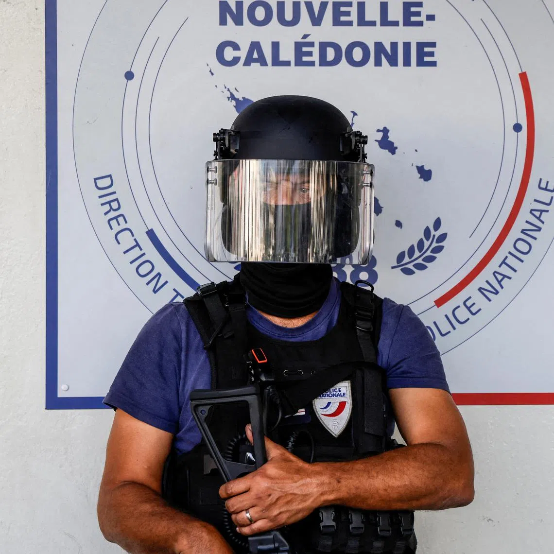 FILE PHOTO: A policeman waits for the arrival of French President Emmanuel Macron at the central police station in Noumea, France's Pacific territory of New Caledonia on May 23, 2024. LUDOVIC MARIN/Pool via REUTERS/File Photo