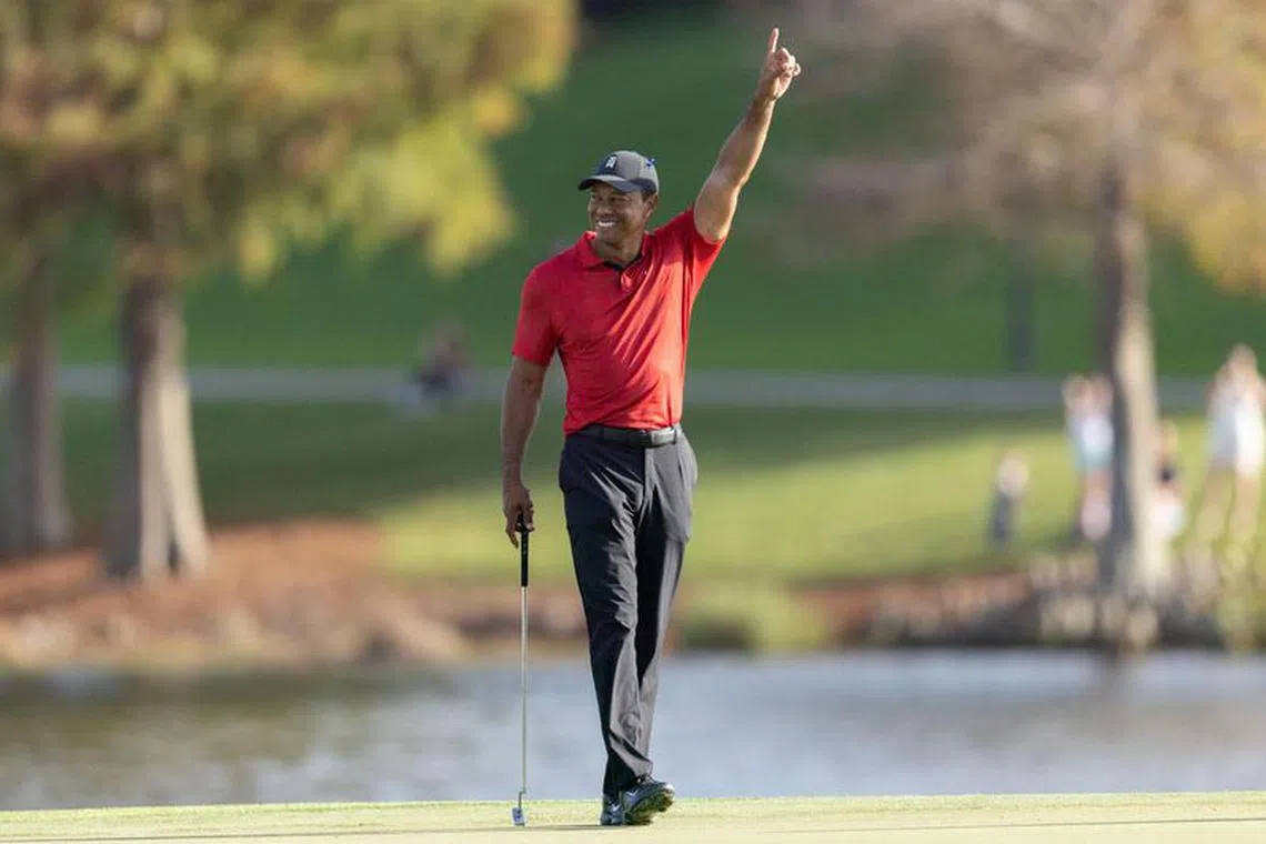 FILE PHOTO: Dec 19, 2021; Orlando, Florida, USA; Tiger Woods reacting to Cameron Kuchar draining a long putt on the 17th green during the final round of the PNC Championship golf tournament at Grande Lakes Orlando Course. Mandatory Credit: Jeremy Reper-USA TODAY Sports/File Photo