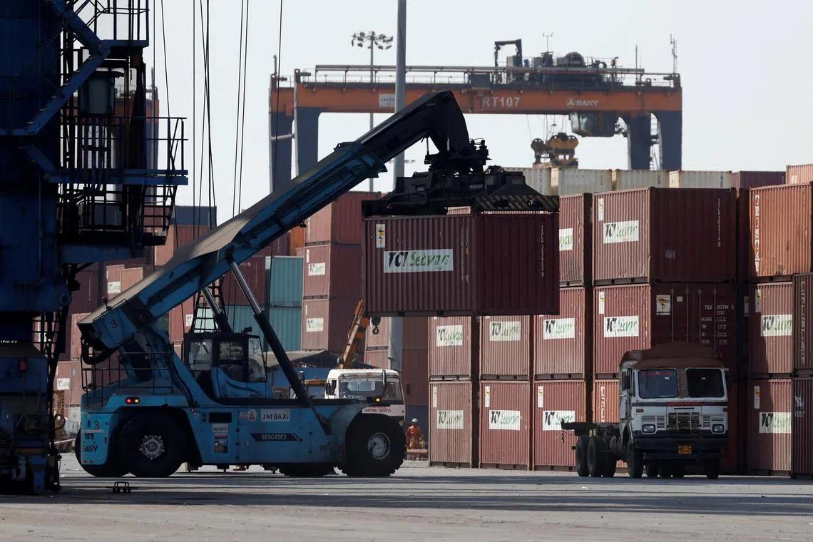 FILE PHOTO: A mobile crane carries a container at Deendayal Port in Kandla, in the western state of Gujarat, India, April 5, 2025.  REUTERS/Amit Dave/ File Photo