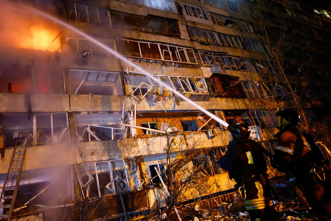 Firefighters work at the site of an apartment building damaged by a Russian missile strike, amid Russia's attack on Ukraine, in Kyiv, Ukraine October 13, 2026. REUTERS/Valentyn Ogirenko