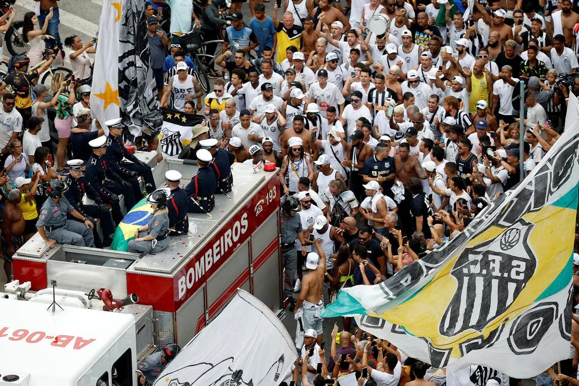 Fans look on as the casket of Brazilian soccer legend Pele is transported to Santos' Memorial Cemetery, Santos, Brazil, Jan 3, 2023. Brazilian soccer legend Pele died on Dec 29, 2022, at the age of 82.