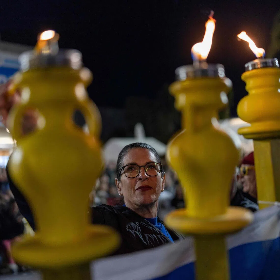Mrs Talik Gvili, the mother of Israeli hostage Ran Gvili, lighting a candle in Tel Aviv on Dec 21, 2025. The body of Mr Gvili remains in Gaza.