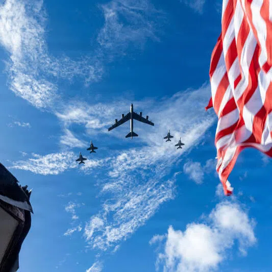 F/A-18E/F Super Hornets and a US Air Force B-52 Stratofortress fly over the US Navy’s Gerald R. Ford Carrier Strike Group in the Atlantic Ocean on Nov 13.