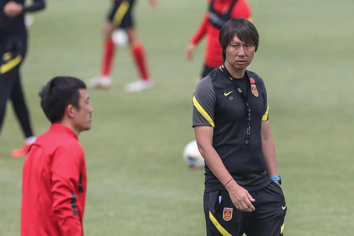 (FILES) In this file photo taken on May 25, 2020 China's head coach Li Tie (R) take part in a training session with members of the Chinese national football team in Shanghai. - Chinese football has been jolted by a new crackdown on corruption that leaves President Xi Jinping's dream of becoming a global force in the sport appear more remote than ever. (Photo by AFP) / China OUT