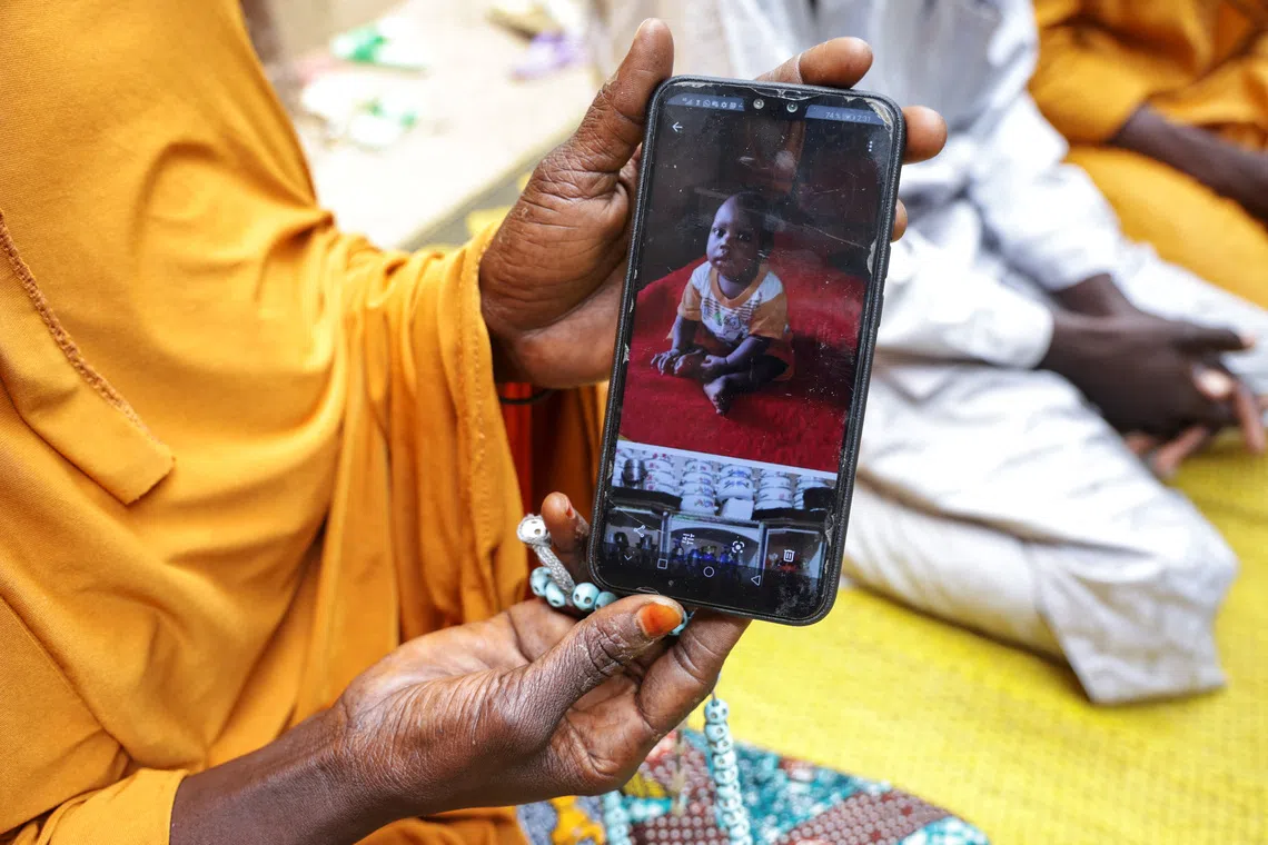 Fatimata Madou, shows a photo of Mohamat, her nine-month old child who died of malaria, in Bogo, Cameroon September 4, 2025. REUTERS/Desire Danga Essigue