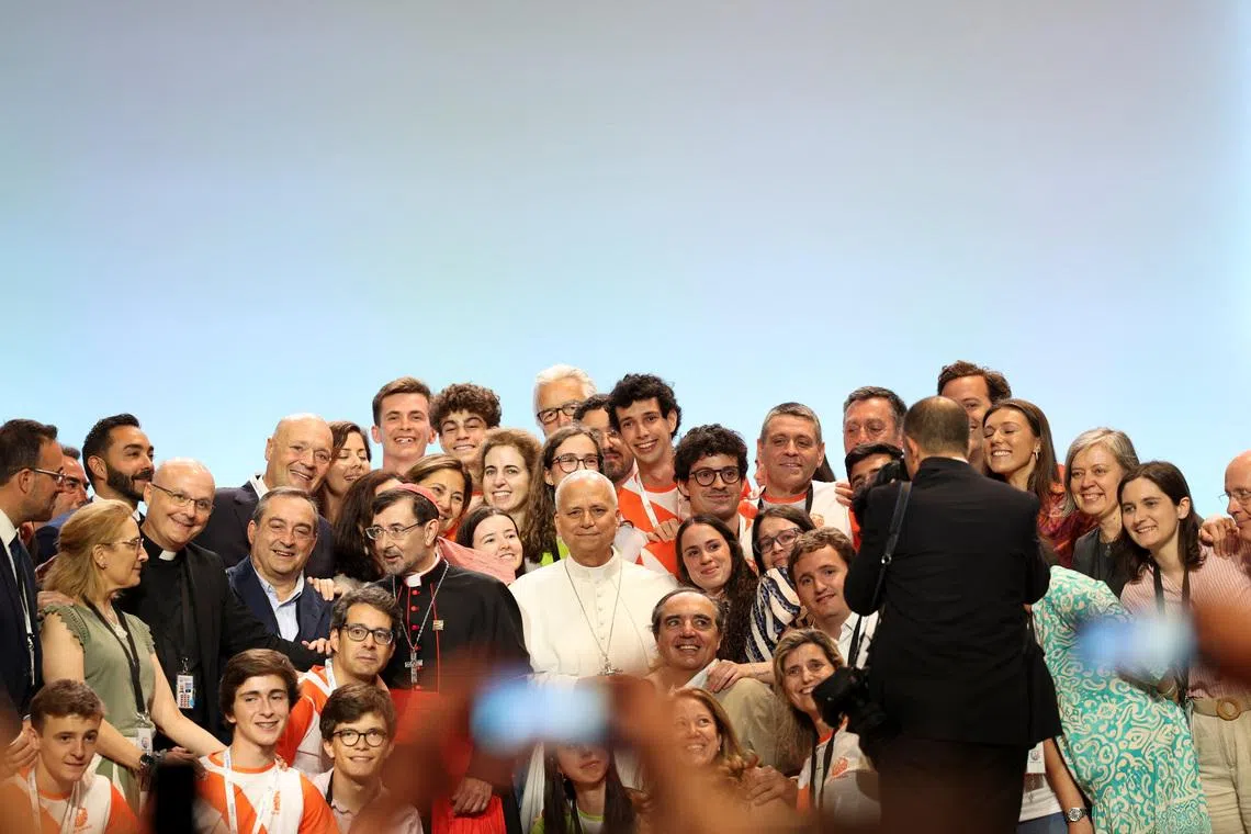 Pope Leo XIV poses for a photograph with with volunteers from the IFEMA centre during his apostolic journey in Madrid, Spain, June 9, 2026. REUTERS/Violeta Santos Moura