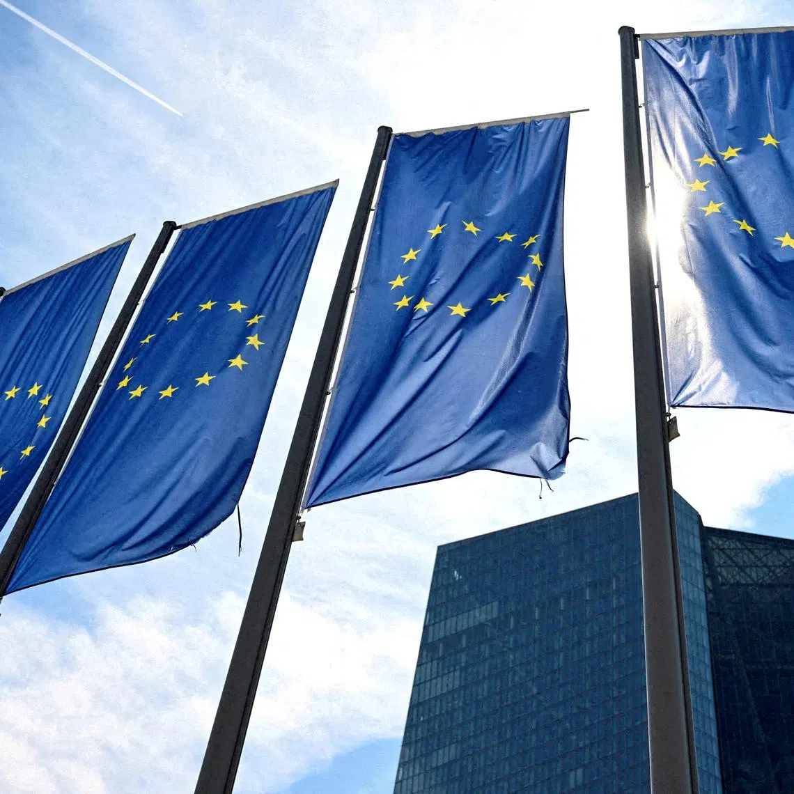FILE PHOTO: EU flags flutter in front of European Central Bank (ECB) headquarters in Frankfurt, Germany July 18, 2024. REUTERS/Jana Rodenbusch/File Photo