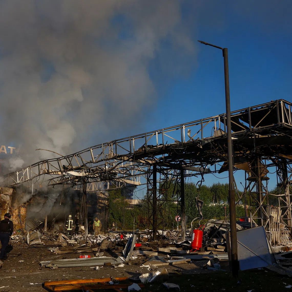 Firefighters work at the site of a petrol station hit by a Russian drone strike in Kyiv, Ukraine on Sept 23.