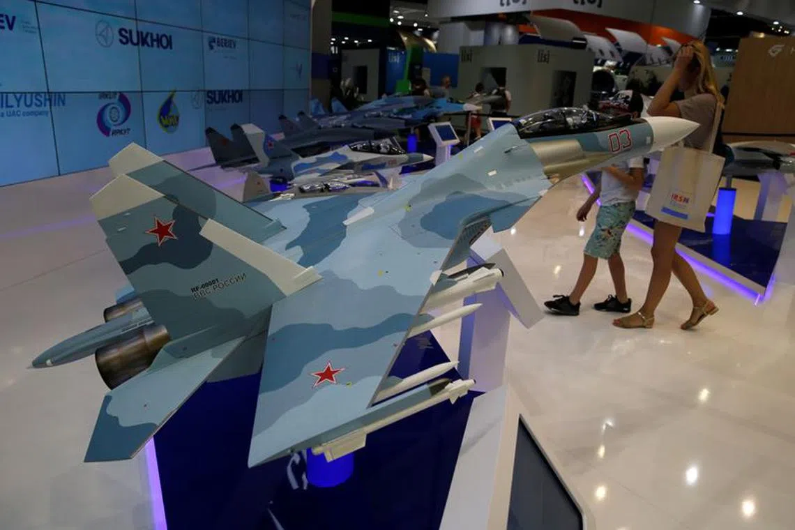 Visitors walk near a model of the Sukhoi Su-30SME multirole fighter at the 53rd International Paris Air Show at Le Bourget Airport near Paris, France June 23, 2019. REUTERS/Pascal Rossignol/file photo