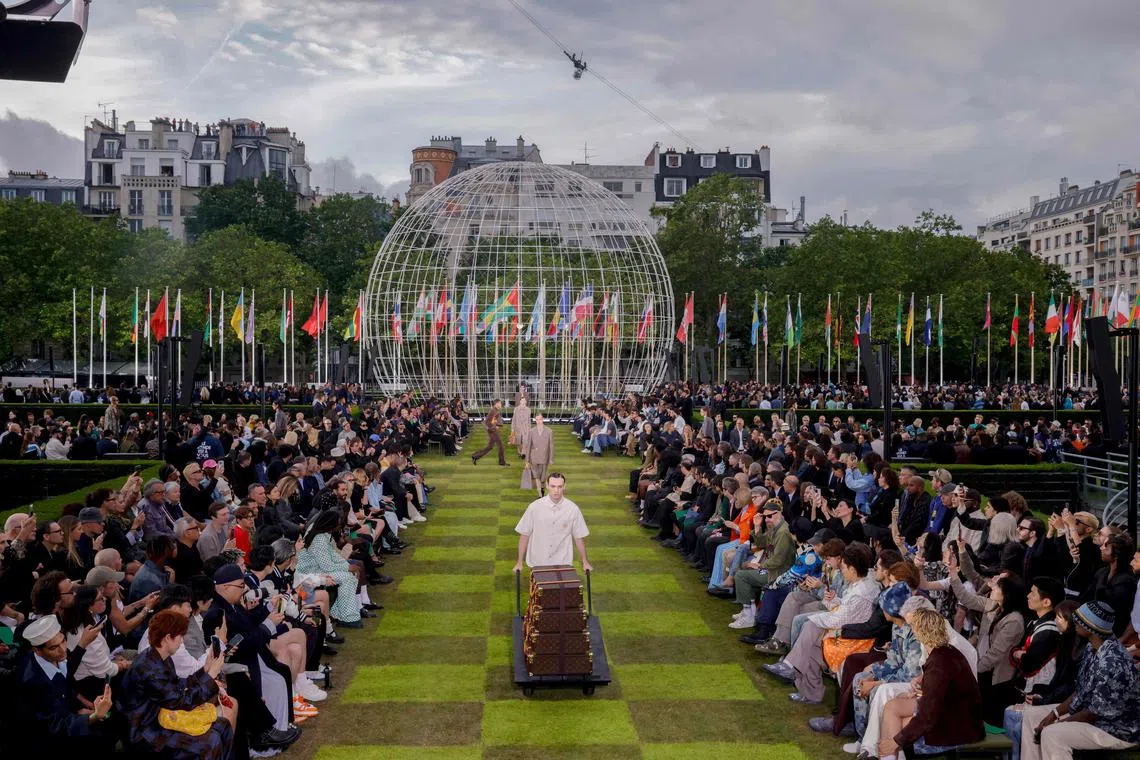 Models presenting creations by Louis Vuitton for the men's ready-to-wear Spring/Summer 2025 collection, as part of Paris Fashion Week, in Paris on June 18, 2024. 