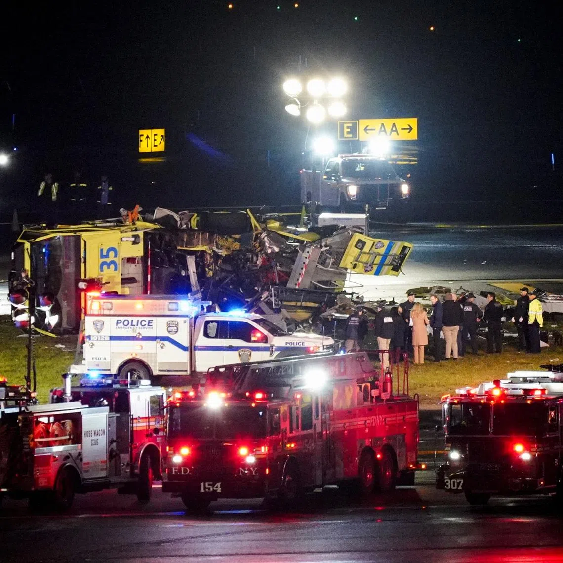 Emergency crews work around a ground vehicle following a collision between the vehicle and an Air Canada Express jet at LaGuardia Airport in Queens, New York, U.S. March 23, 2026. REUTERS/Bing Guan
