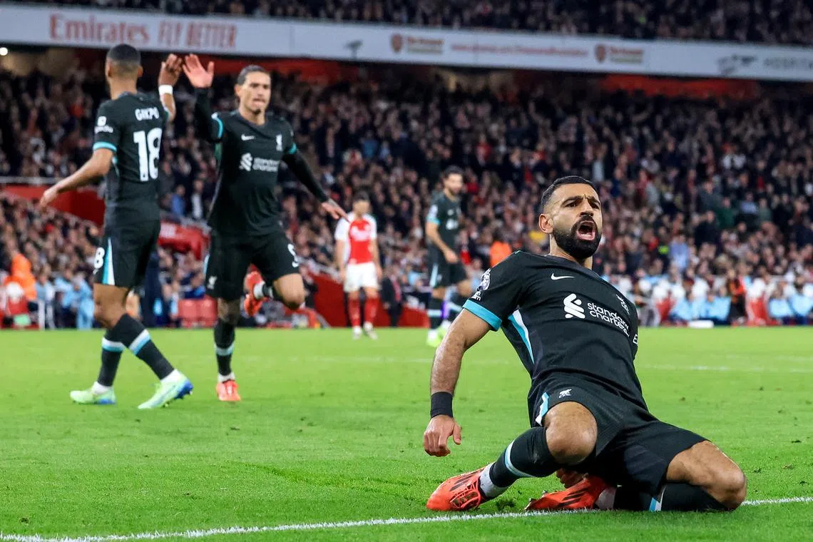 Mohamed Salah of Liverpool (right) celebrates after scoring the 2-2 goal during the match between Arsenal FC and Liverpool FC.