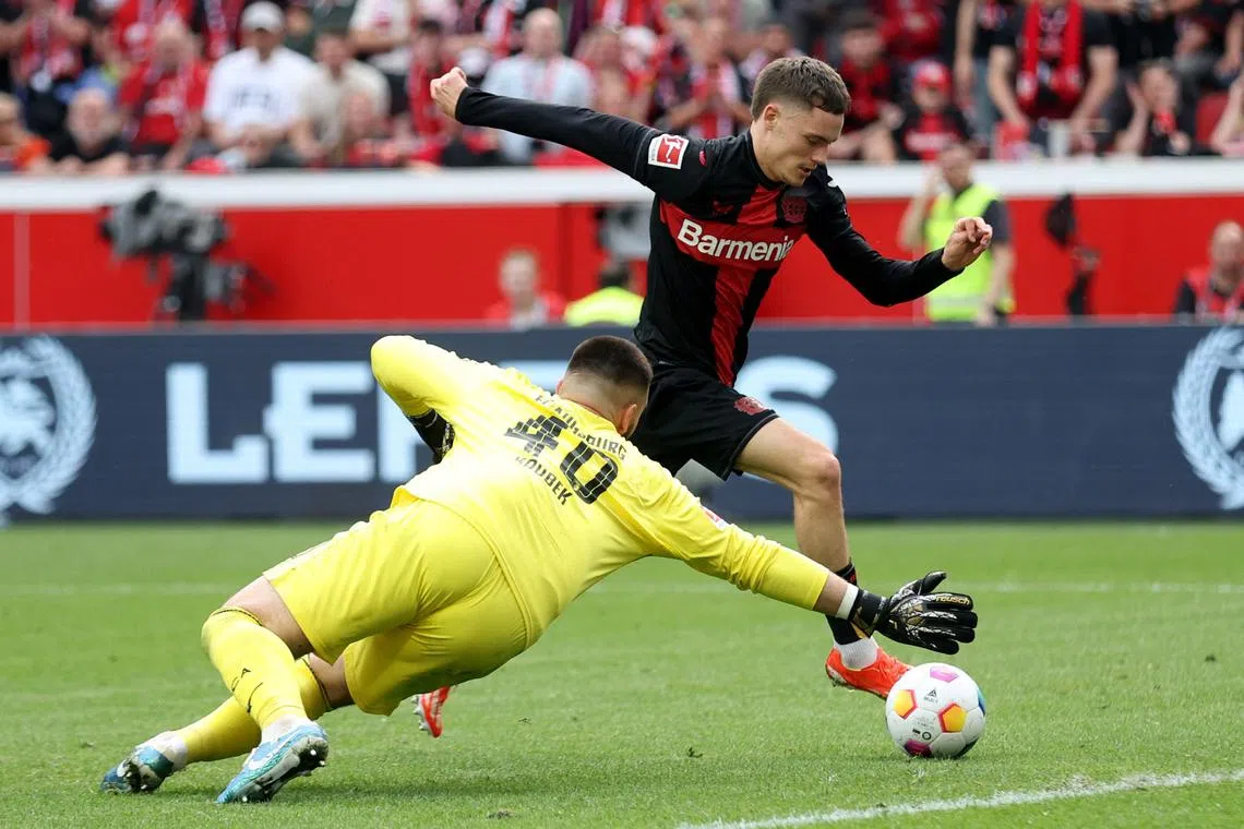 Soccer Football - Bundesliga - Bayer Leverkusen v FC Augsburg - BayArena, Leverkusen, Germany - May 18, 2024 Bayer Leverkusen's Florian Wirtz in action with FC Augsburg's Tomas Koubek REUTERS/Thilo Schmuelgen