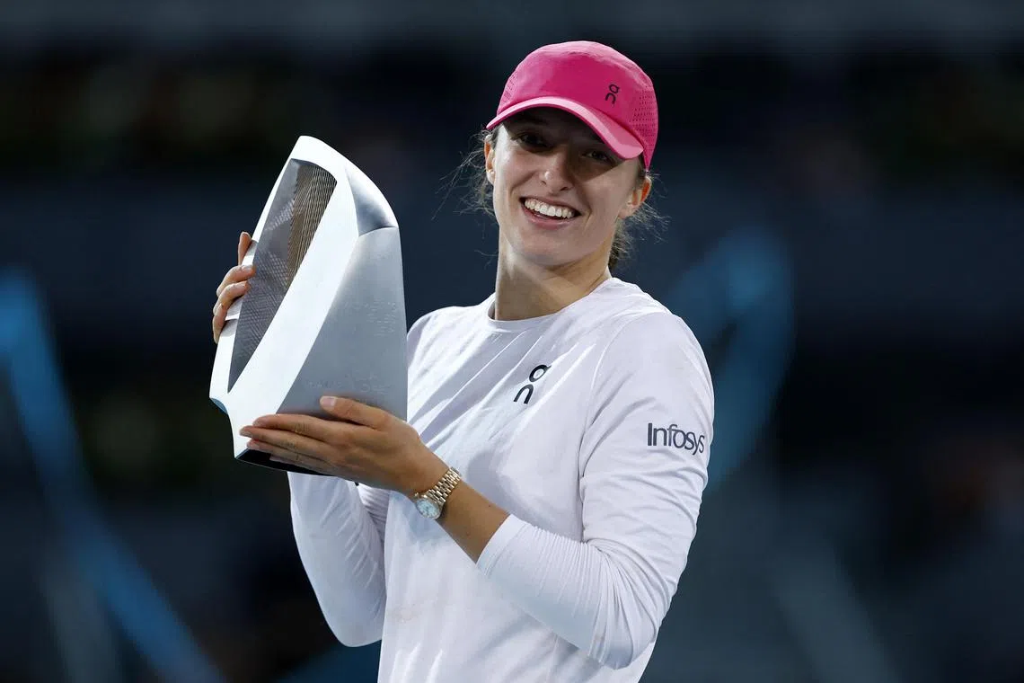 Poland's Iga Swiatek celebrates with the trophy after winning her final match against Belarus' Aryna Sabalenka.