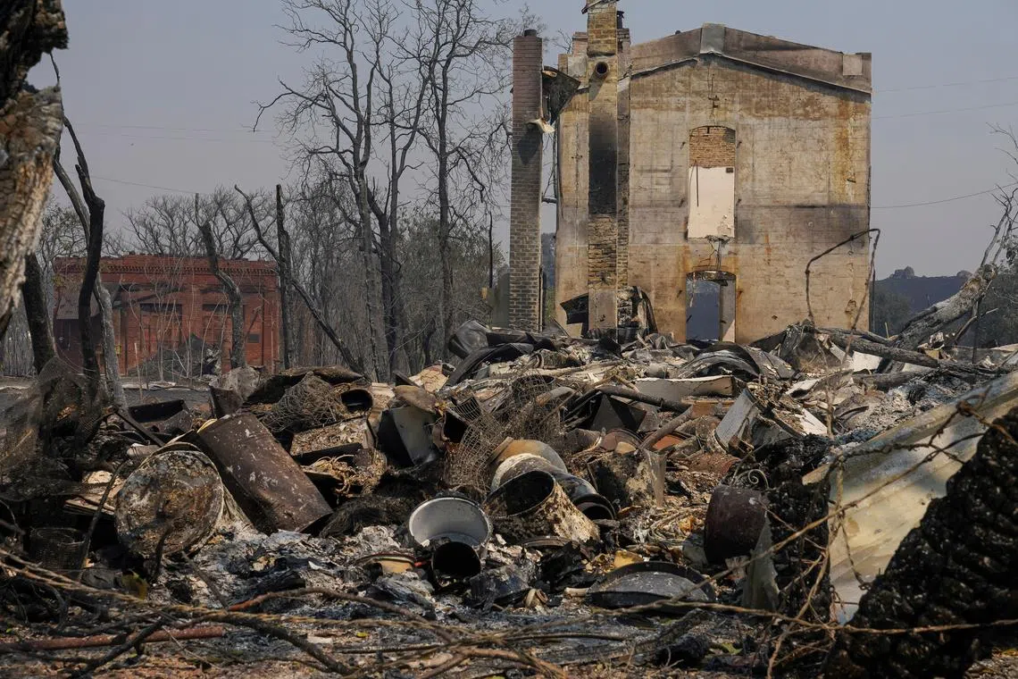 Shells of historic buildings remain standing in the Chinese Camp devastation as wildfires rage in Tuolumne County, California, U.S., September 3, 2025.  REUTERS/Tracy Barbutes