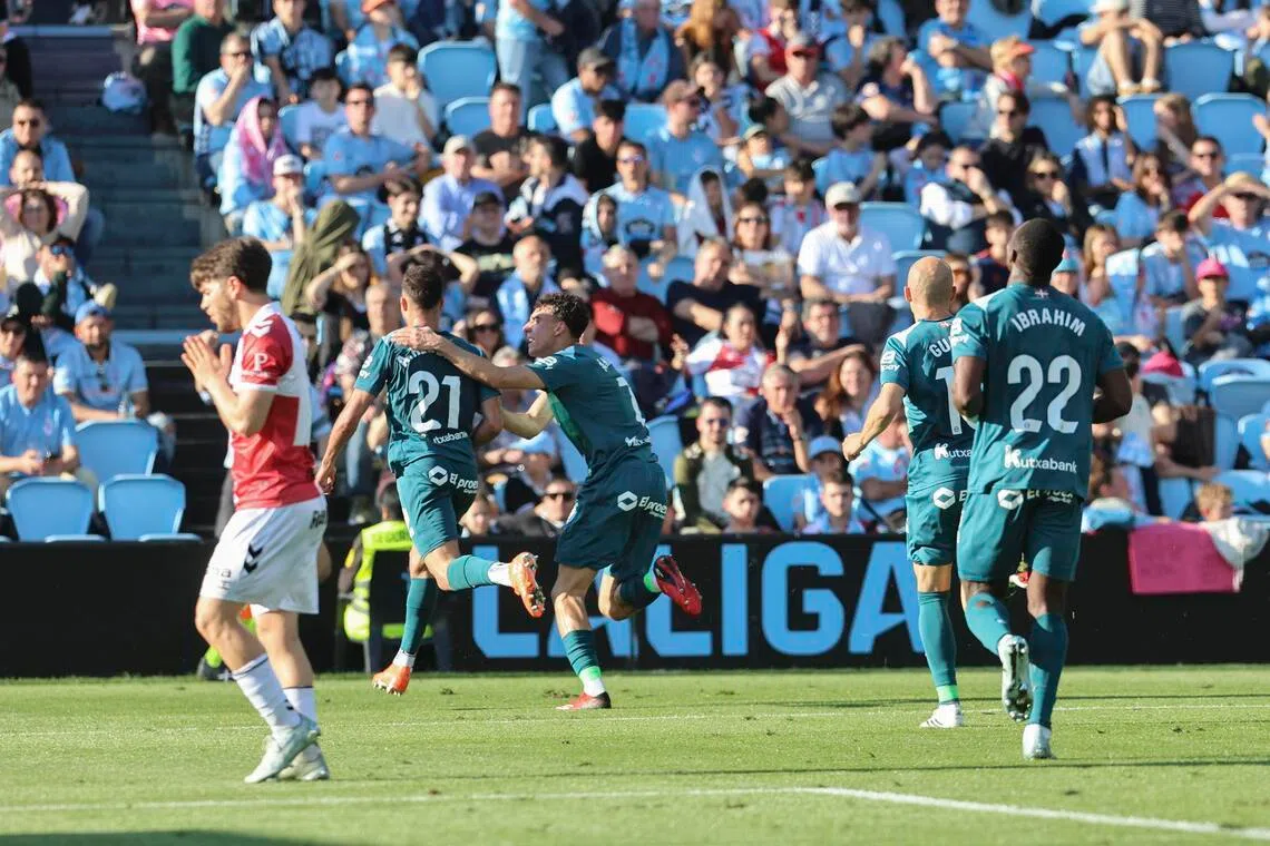Alaves players celebrate the winning goal scored by Abde Rebbach against Celta Vigo in their Spanish La Liga soccer match in Vigo on March 22, 2026.