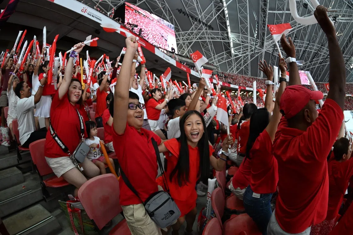 The spectators doing the Kallang wave at the National Day Parade 2026 at the National Stadium on Aug 9, 2026. ST PHOTO: Chong Jun Liang