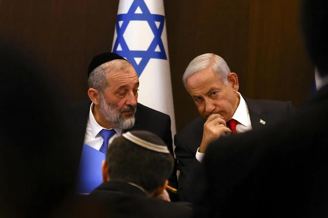 Mr Netanyahu (R) had taken no apparent action Thursday on removing his interior minister, Aryeh Deri (L), a day after the country’s highest court ruled that the minister should be fired.