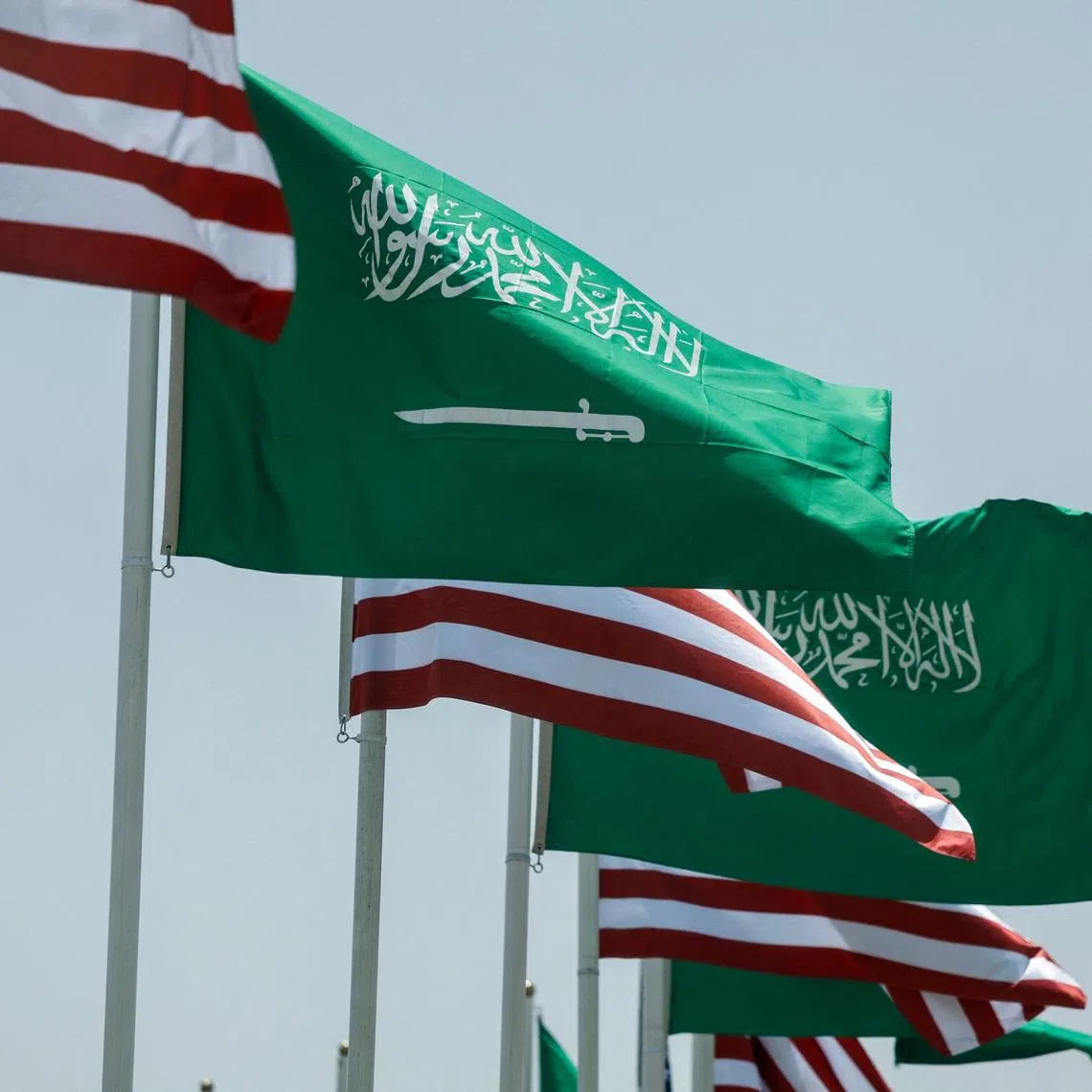 FILE PHOTO: U.S. and Saudi flags flutter along a highway of Riyadh, as pictured through the glass of a car, ahead of the arrival of U.S. President Donald Trump to Riyadh, Saudi Arabia May 12, 2025. REUTERS/Hamad I Mohammed/ File Photo