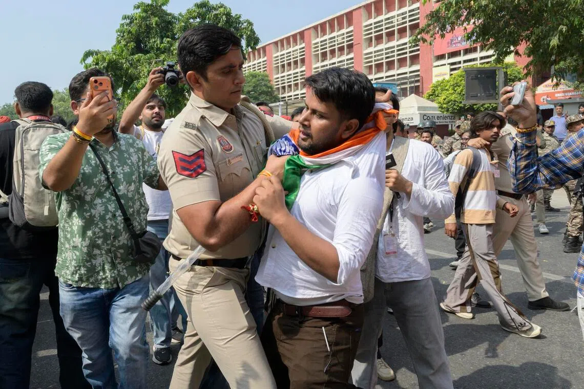 Security personnel confronting protesters in New Delhi, India, on Oct 10.