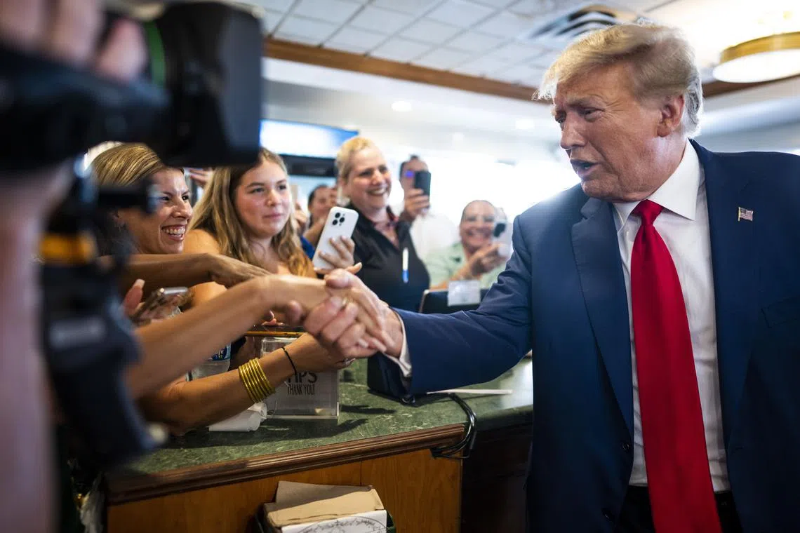 Former President Donald Trump greets people during a stop at the Versailles restaurant after his arraignment in the Little Havana neighborhood in Miami, June 13, 2023. (Doug Mills/The New York Times)