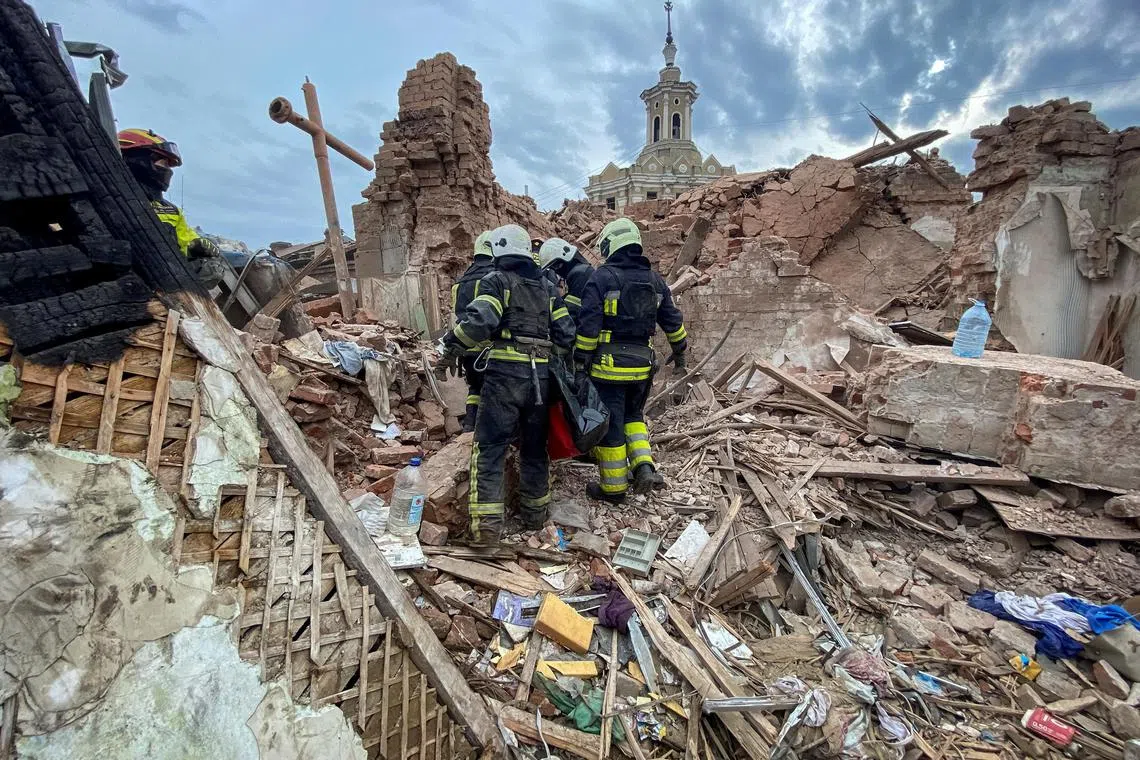 Rescuers carry the body of a 10-year-old boy, named Tymofii, from the debris of a Russian missile strike, in Kharkiv, Ukraine.