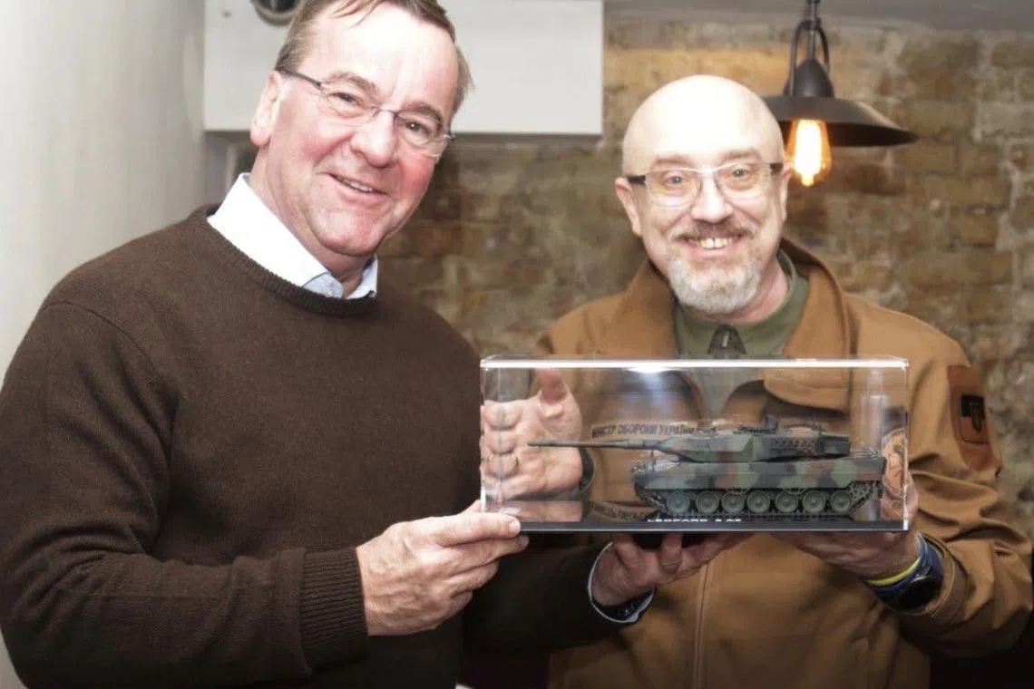 Ukrainian defence minister Oleksii Reznikov tweeted a photo of himself (right) and Mr Pistorius holding a model replica of Germany's Leopard tank.