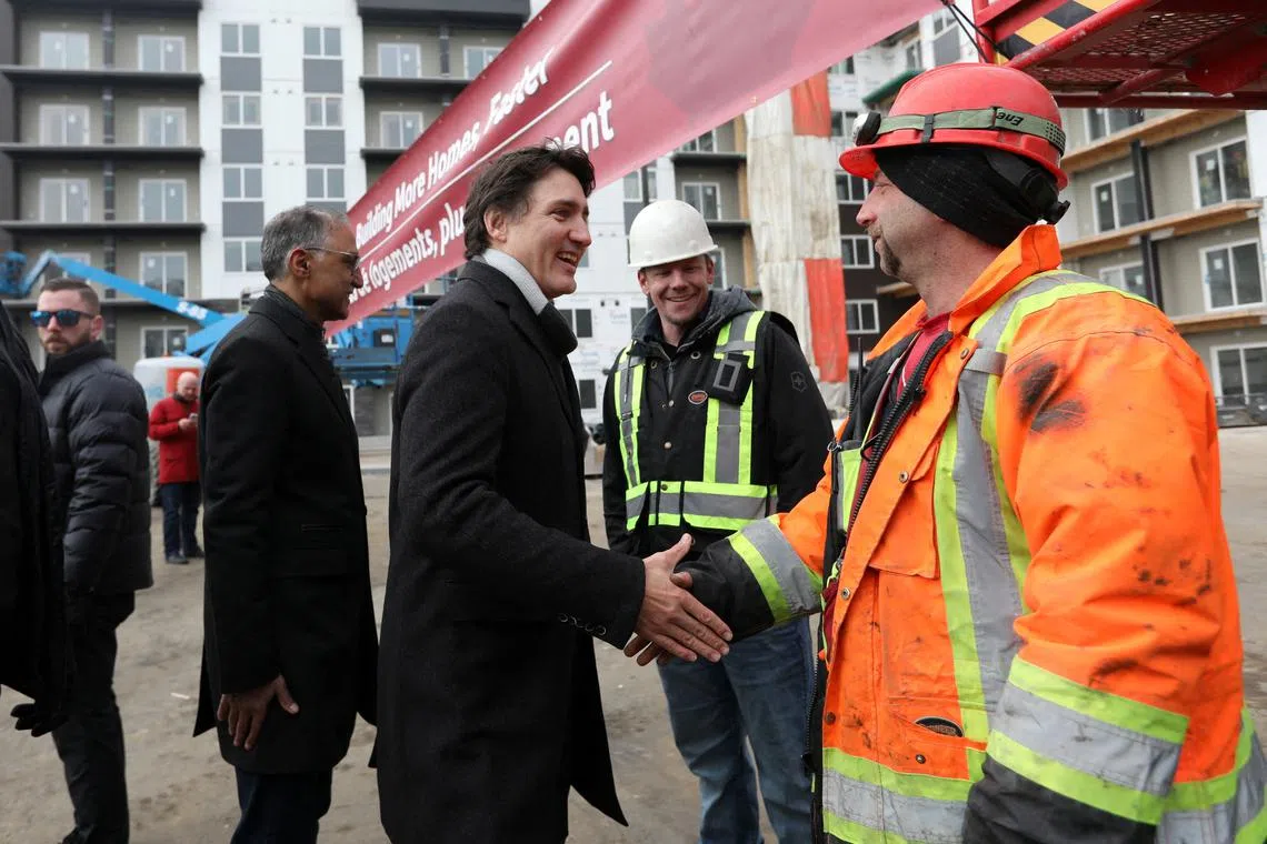 Canada’s Prime Minister Justin Trudeau meets workers as he tours new construction at Edgemont Flats housing complex during an announcement of new funding for housing in Edmonton, Alberta, Canada February 21, 2024. REUTERS/Amber Bracken