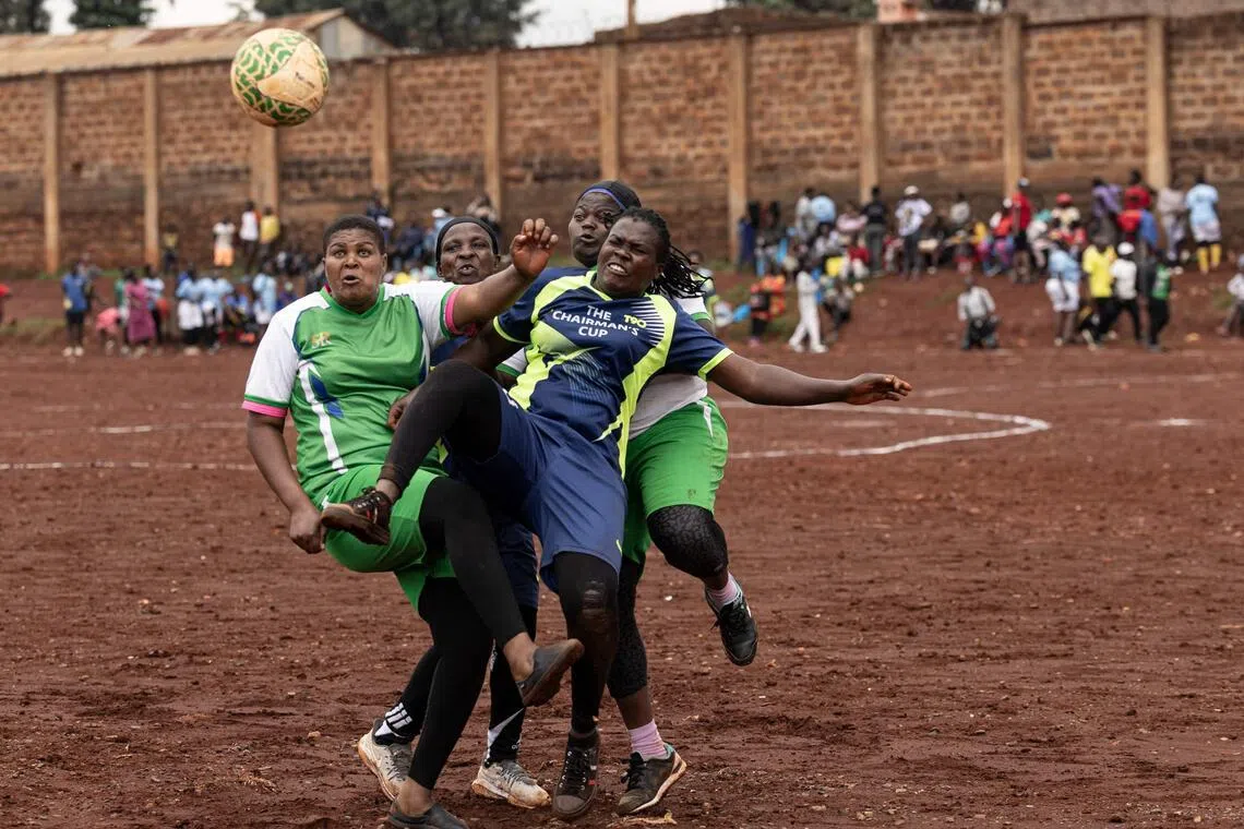 TOPSHOT - Women resident of Kawangware vie for the ball as they participate in a football tournament during the Mother’s Day Women Peace Cup in the Kawangware informal settlement of Nairobi on May 9, 2026. The initiative is aimed to bring peace, unity and social cohesion through sports and community  engagement, and to bridge the gap among diverse communities living in the informal settlement. (Photo by SIMON MAINA / AFP)