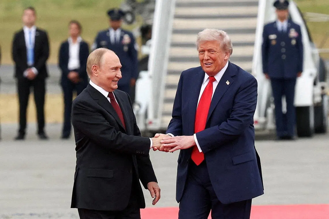 FILE PHOTO: U.S. President Donald Trump shakes hand with Russian President Vladimir Putin, as they meet to negotiate for an end to the war in Ukraine, at Joint Base Elmendorf-Richardson in Anchorage, Alaska, U.S., August 15, 2025. REUTERS/Kevin Lamarque/File Photo