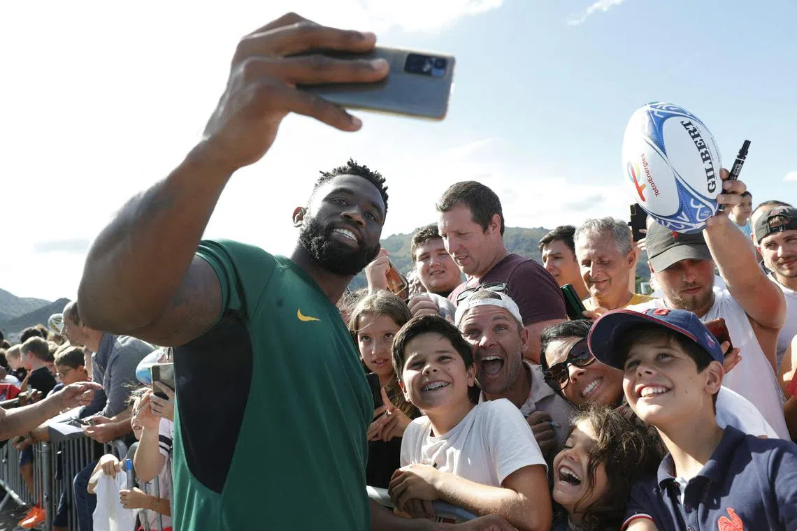 South Africa captain Siya Kolisi takes pictures with fans after a training session in August on the island of Corsica.