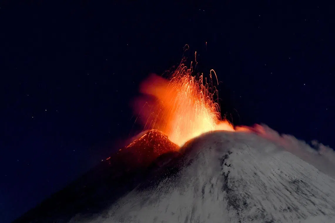 The snow-capped Etna spews hot lava, near Catania, Sicily, Italy, Nov 27. One of Europe's most active and tallest volcanos has erupted again on Nov 25.  