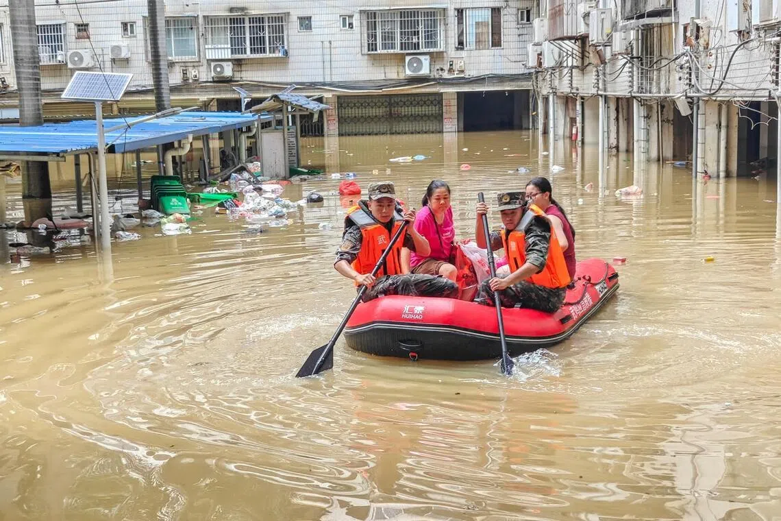 Paramilitary police officers evacuate residents in a rubber dinghy through a flooded area after rainfall brought by typhoon Maysak, in Nanning, Guangxi Zhuang Autonomous Region, China July 6, 2026. cnsphoto via REUTERS   ATTENTION EDITORS - THIS IMAGE WAS PROVIDED BY A THIRD PARTY. CHINA OUT.