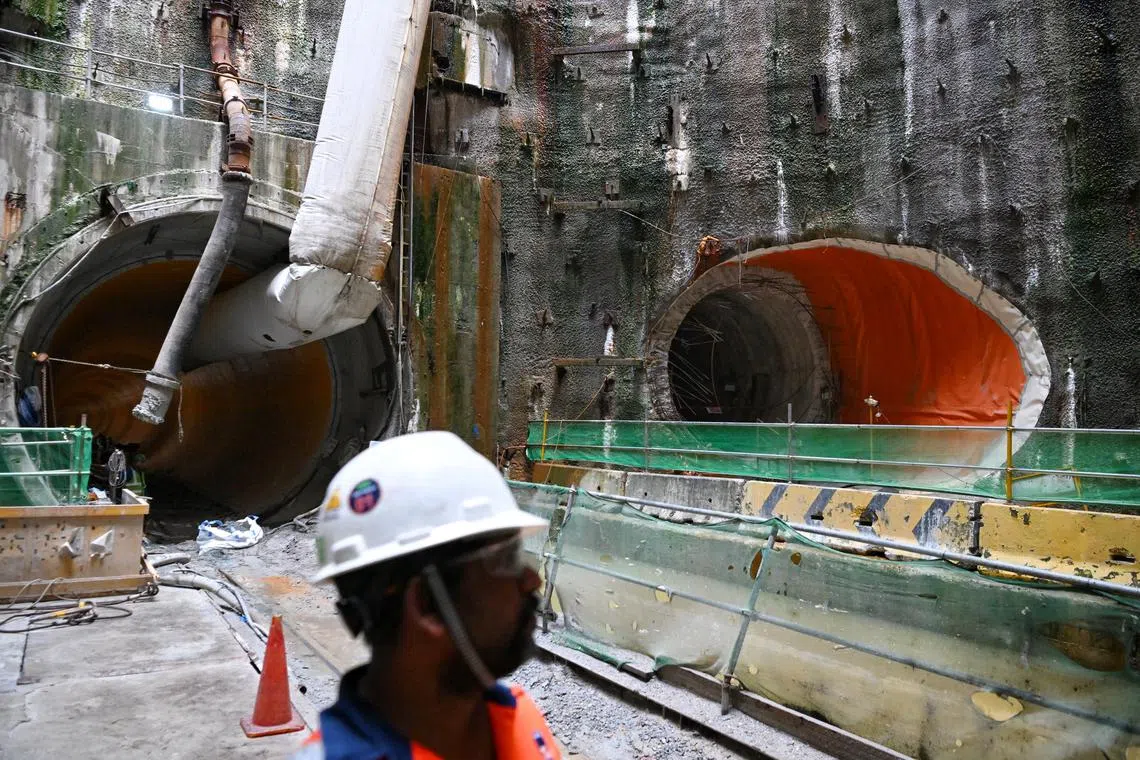 A worker standing between the completed Deep Tunnel Sewerage System Phase 2 (DTSS2) Tunneling Works (left) and the Link Sewer (right) at the tunneling site in Penjuru Road on Aug 17, 2023. 