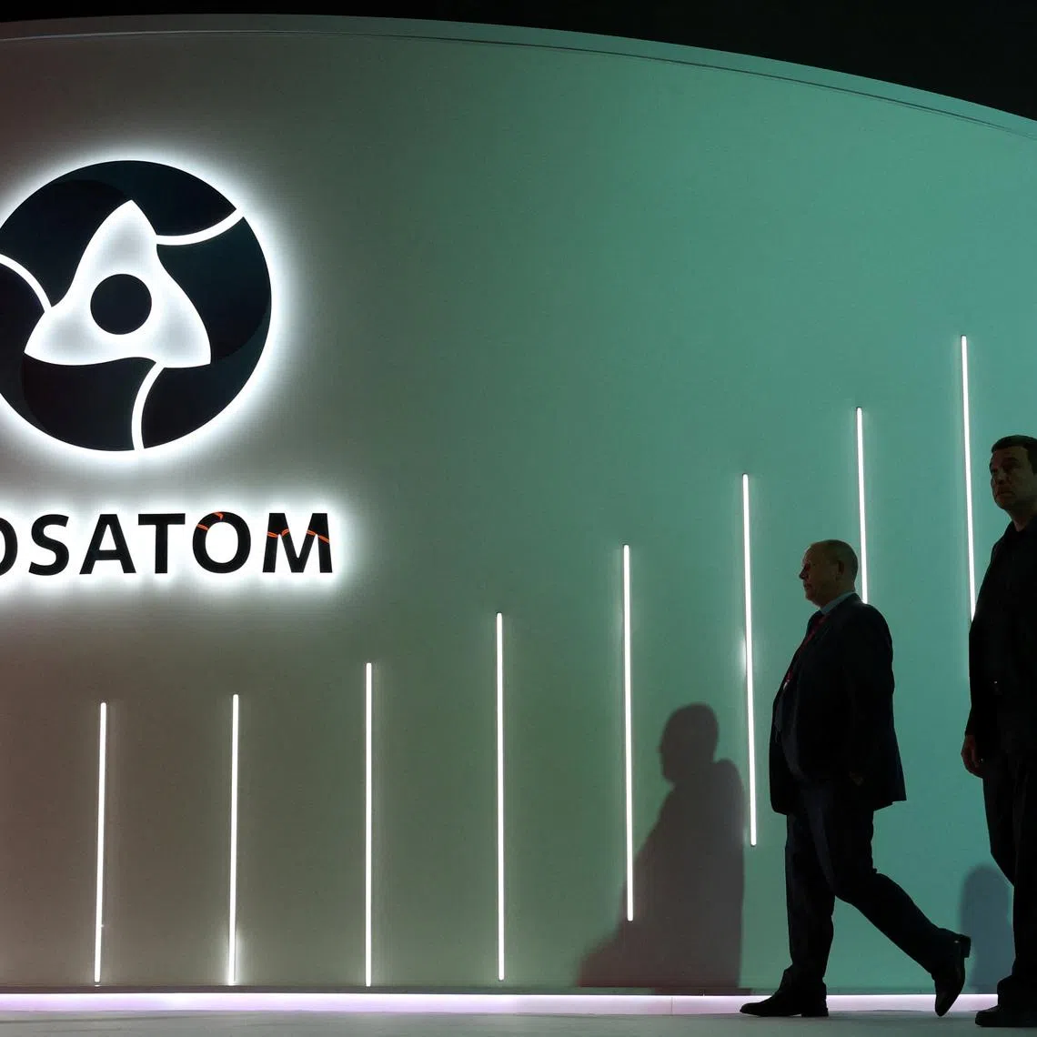 Men walk past an exhibition stand of Russia's State Atomic Energy Corporation Rosatom at the Russian Energy Week international forum in Moscow, Russia, October 15, 2025. REUTERS/Ramil Sitdikov