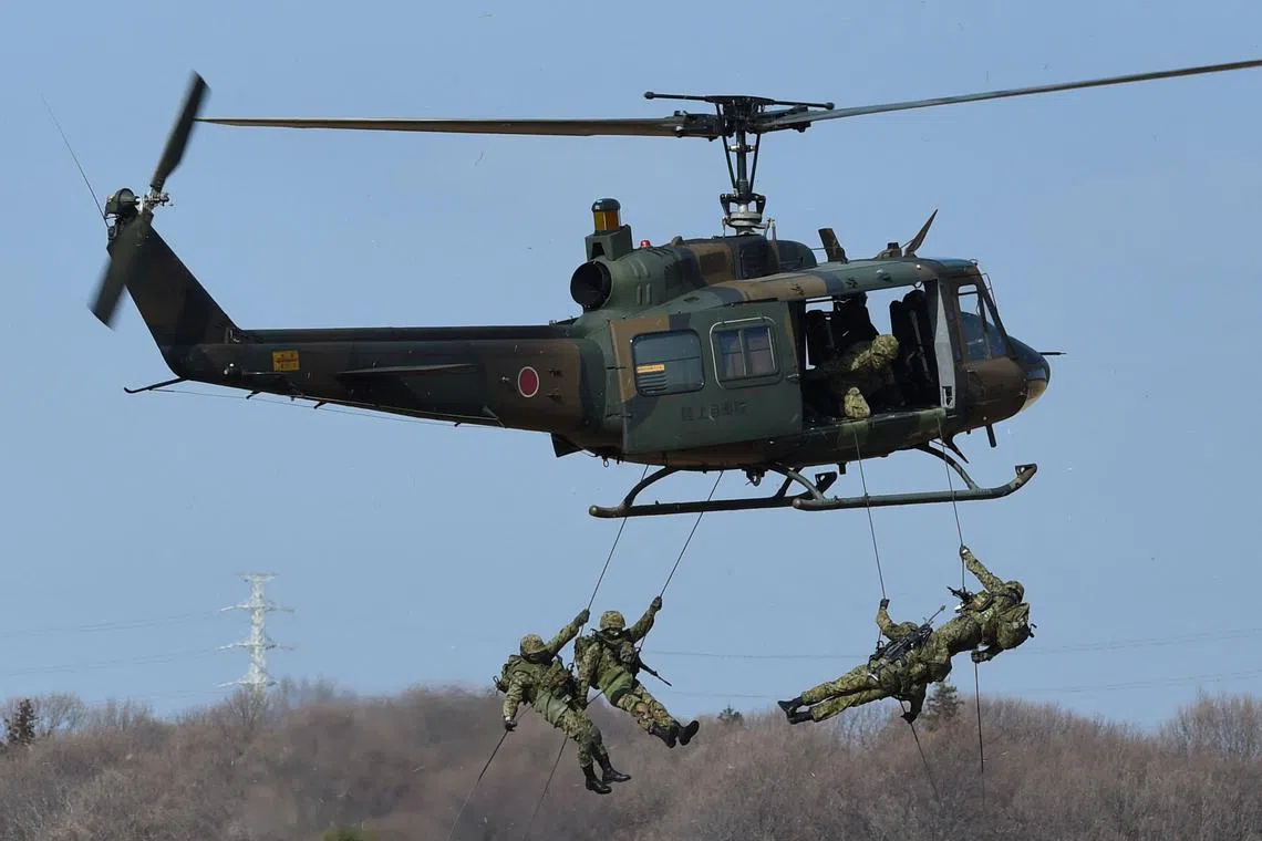 Tokyo has been forced to reduce its ambitious defence procurement plan after the yen lost 10 per cent of its value since the plan was released.