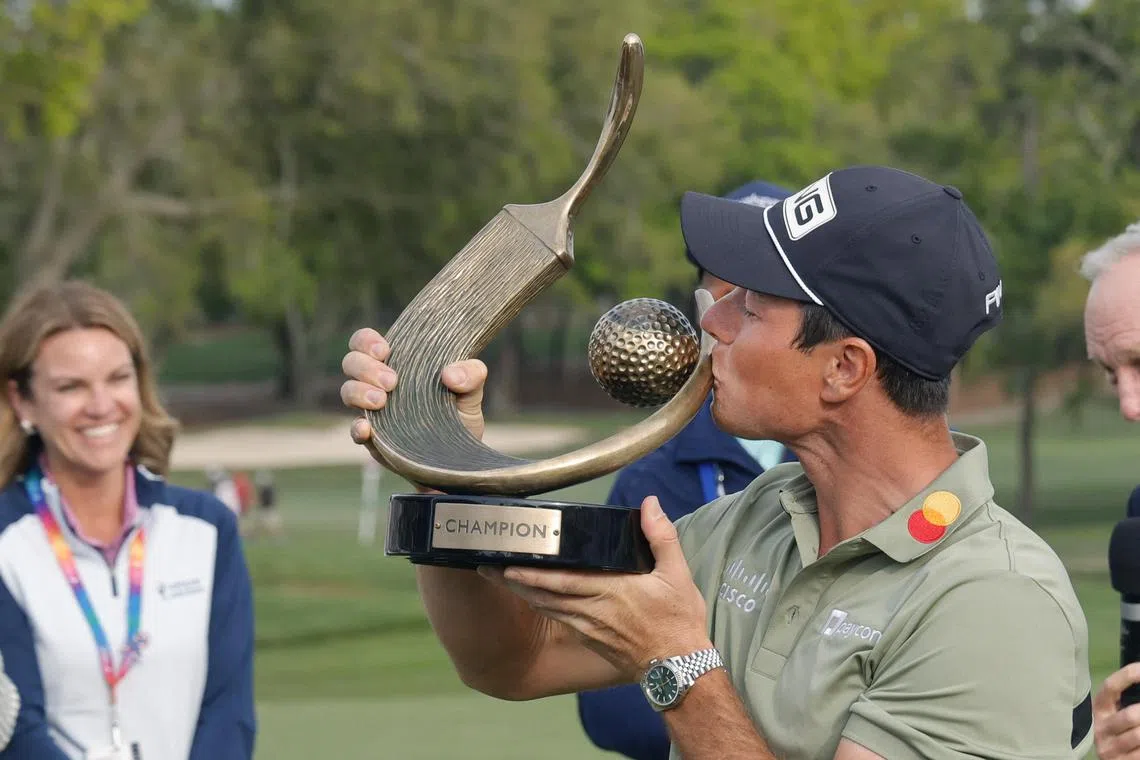 Viktor Hovland kissing the champions trophy after winning the Valspar Championship golf tournament at Innisbrook Resort in Palm Harbor, Florida, on March 23.