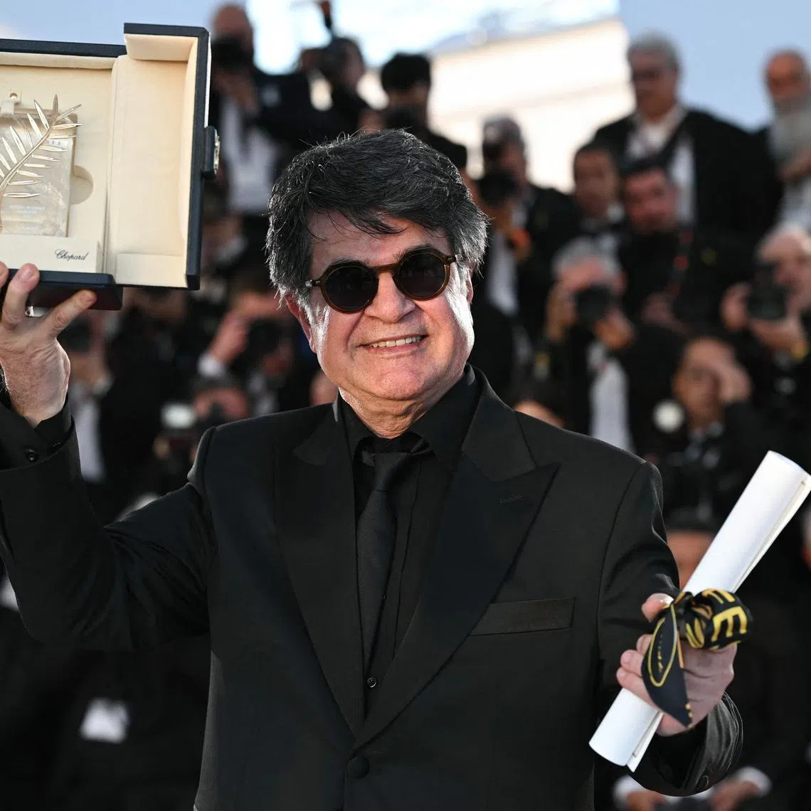 Iranian director, screenwriter and producer Jafar Panahi posing with his Palme d'Or 
trophy at the Cannes Film Festival on May 24.