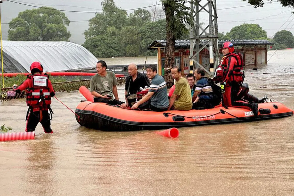 Rescue workers evacuating flood-affected residents with a boat in Minhou county after heavy rains brought by typhoon Haikui, in Fuzhou, Fujian province, China September 5, 2023. cnsphoto via REUTERS