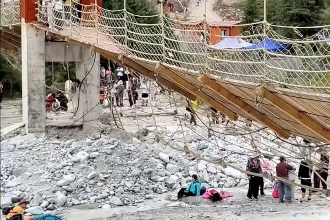 Aftermath of a suspension bridge collapse in Yili, Xinjiang Uyghur Autonomous Region, China in this screen grab obtained from a social media video on date given as August 6, 2025. Social Media/via REUTERS