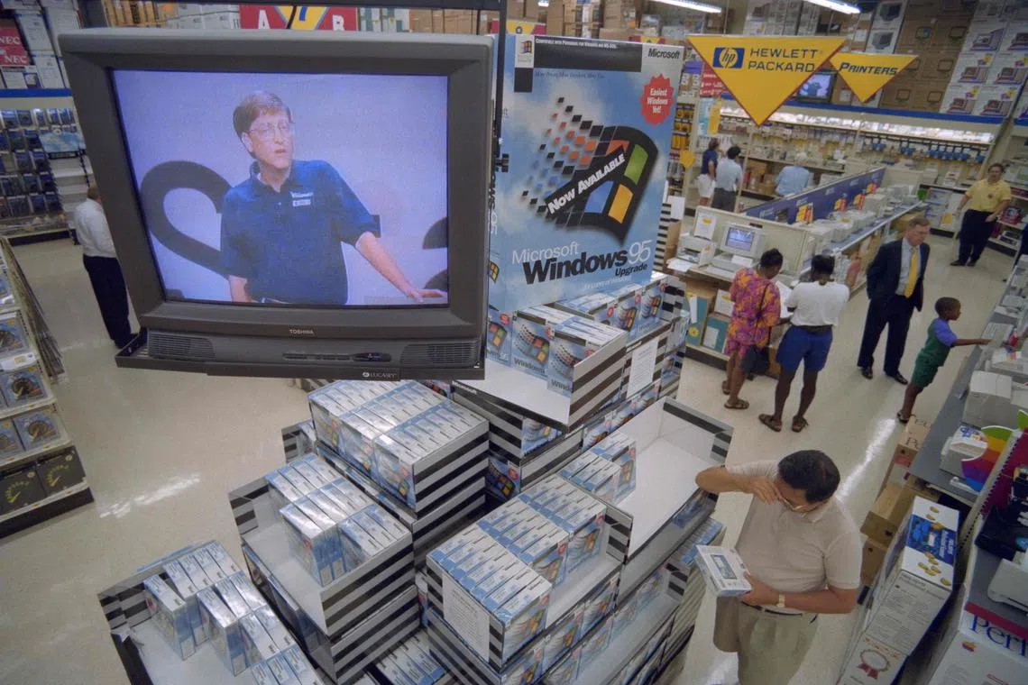 (FILES) Microsoft Corporation Chairman Bill Gates appears via television to promote his company's Window's 95 software at a Computer City Store in Vienna on August 24, 1995. Microsoft has been at the heart of computing for half a century, becoming a tech stalwart almost taken for granted as lifestyles embraced the internet. As the Redmond, Washington-based company founded with a vision of putting computers in every home and office celebrates its 50th anniversary on April 4, it looks to boost its fortunes by being a leader in artificial intelligence. (Photo by Paul J. RICHARDS / AFP)